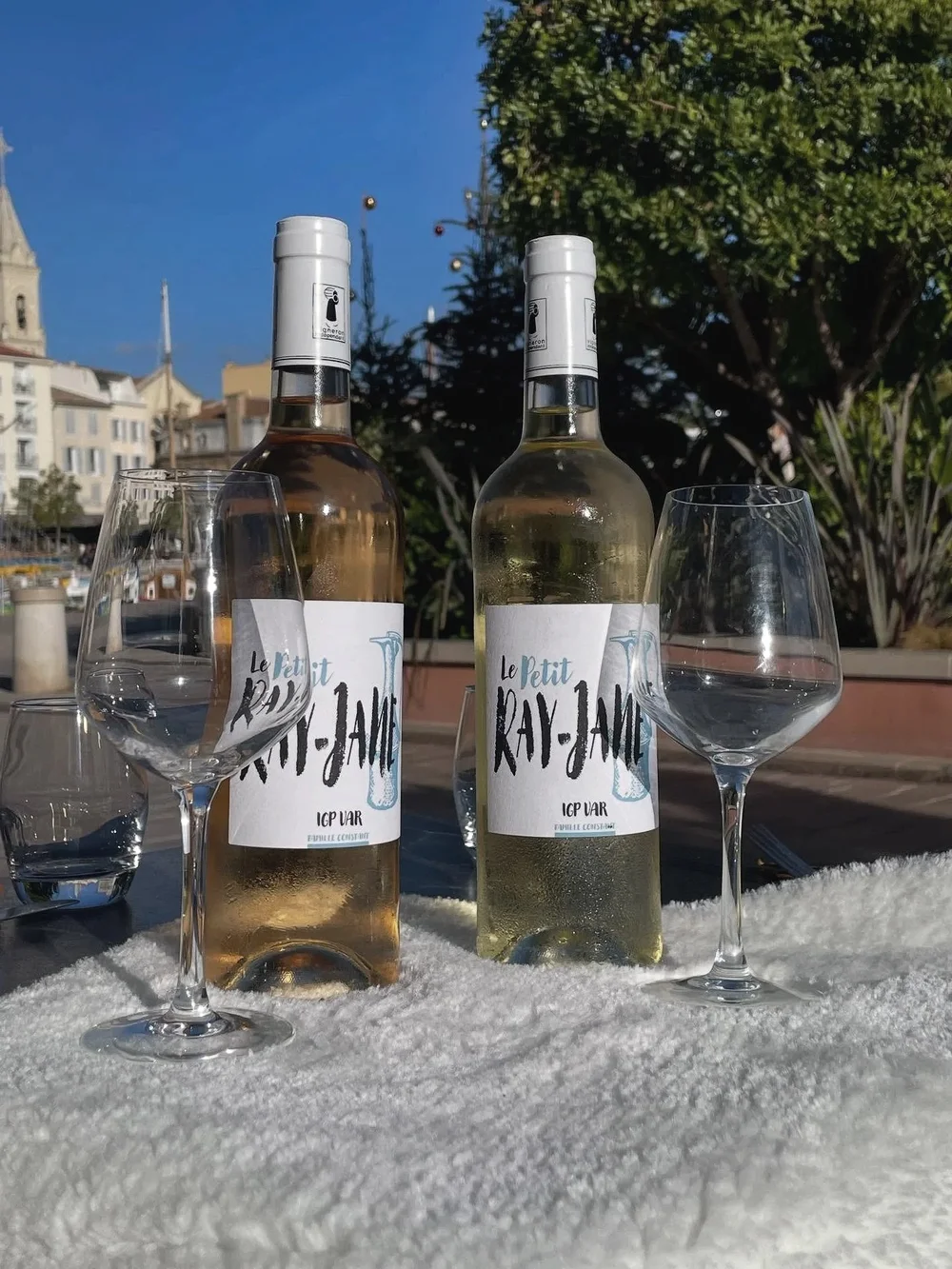 Deux bouteilles de vin de Bandol et deux verres, face au port